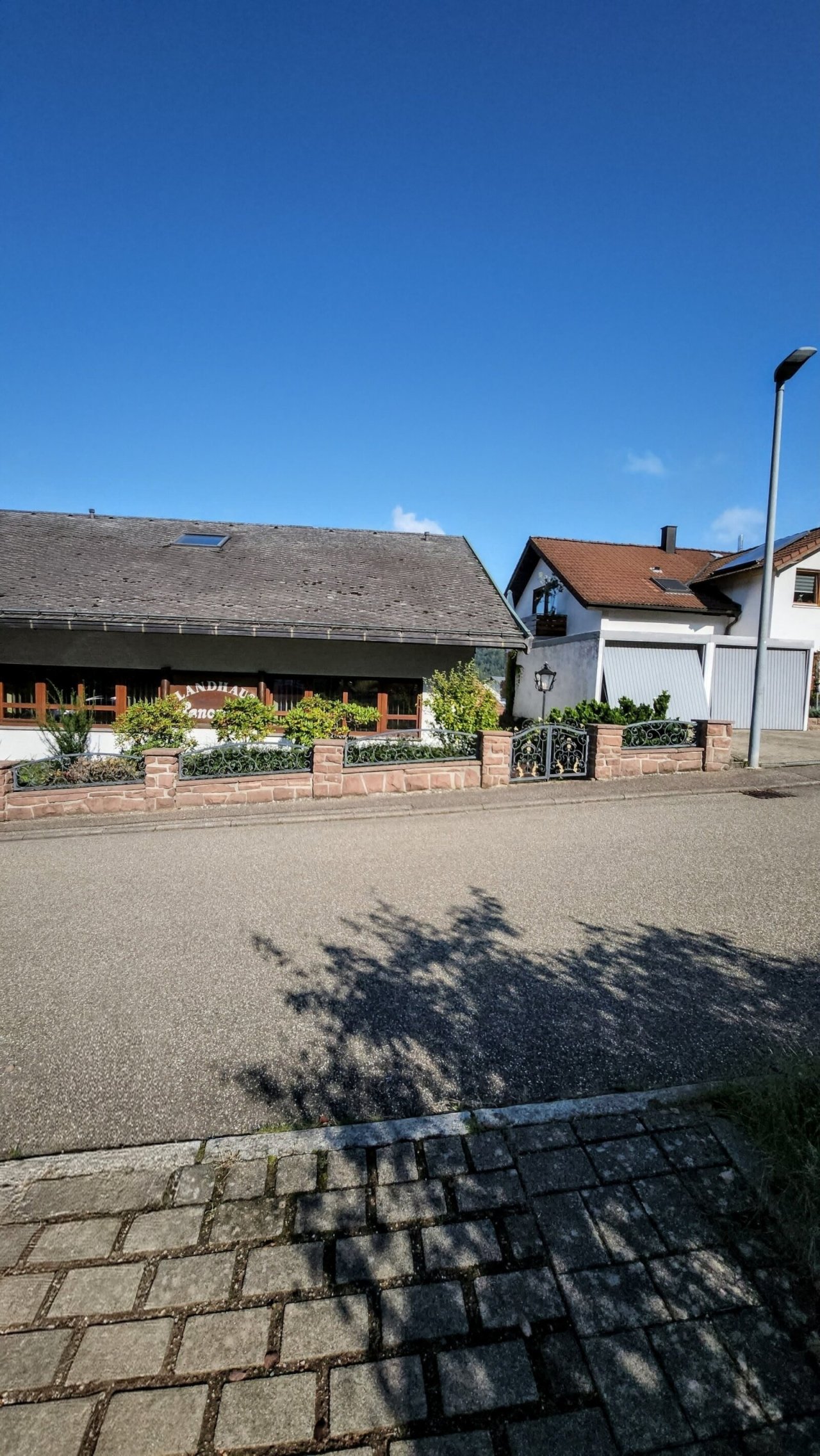 Repräsentative Gewerbeimmobilie mit charmantem Straßenzugang und dekorativer Natursteinmauer